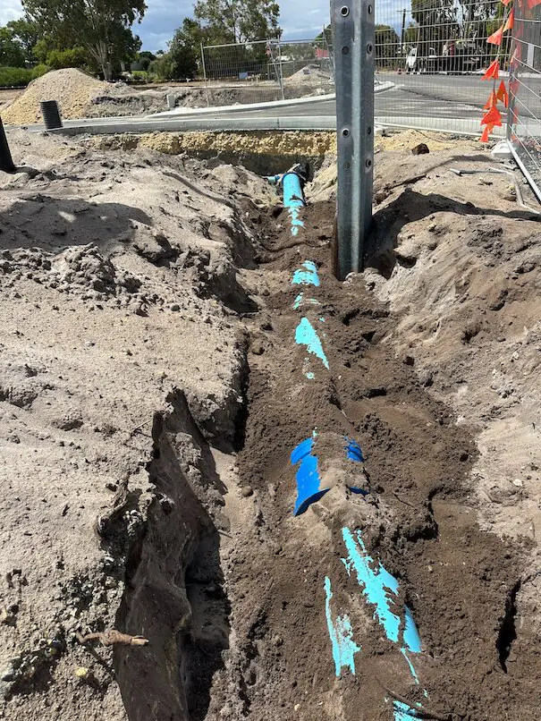 Water main excavation among existing utilities in Henley Brook